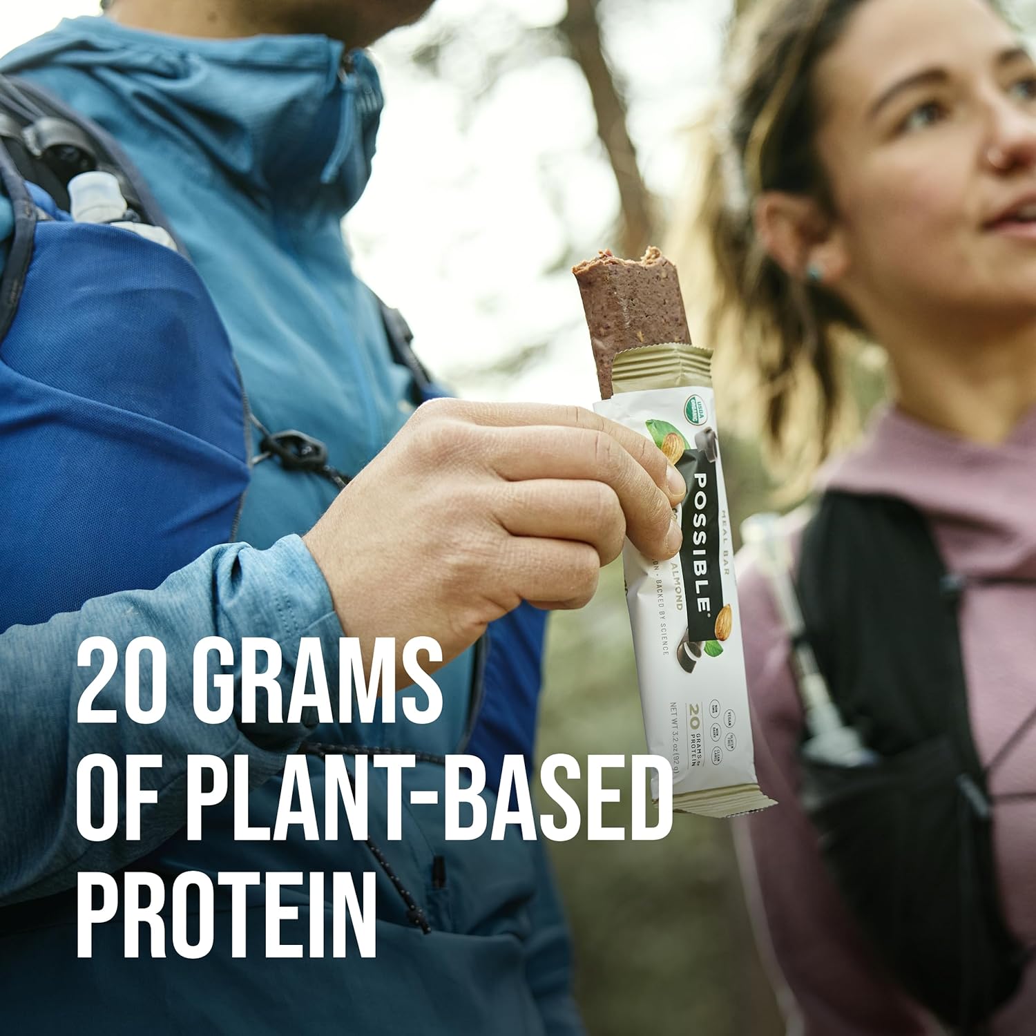 A lifestyle image of two people outdoors, enjoying the POSSIBLE meal bar, with the text "20 grams of plant-based protein," promoting it as a healthy adventure snack