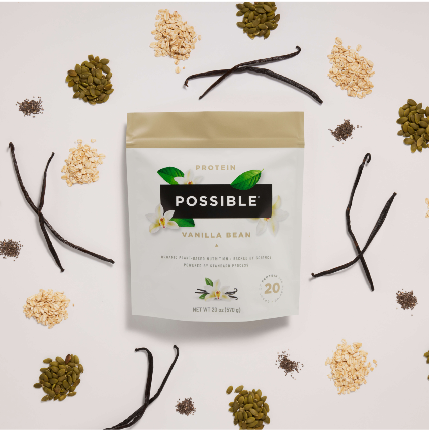 Flat lay of Possible Protein Powder with natural ingredients like cacao, vanilla, and plant-based proteins arranged aesthetically.