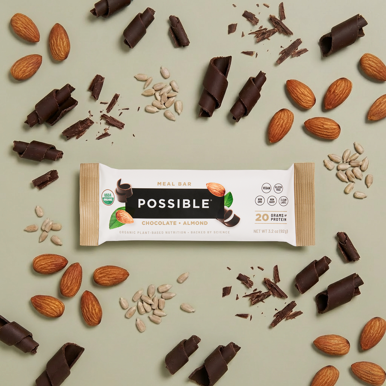 Possible brand chocolate almond meal bar with ingredients on a light green background